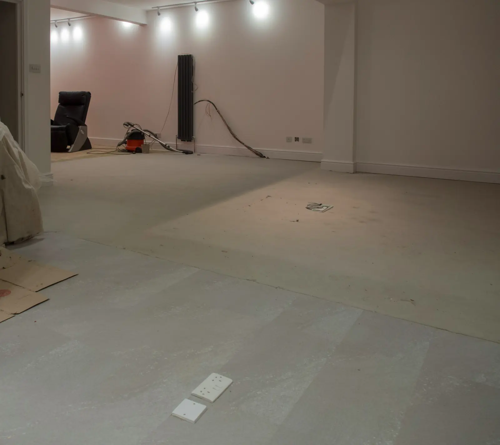 Room cleared with a flat, prepared subfloor ready for hardwood installation